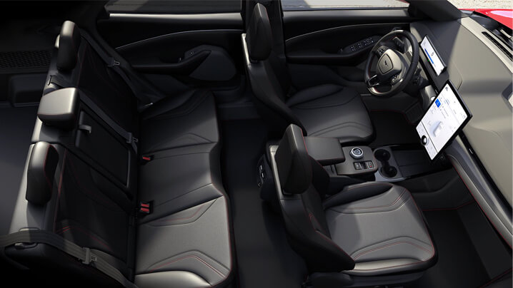 Innenansicht eines modernen Autos mit Ledersitzen und zwei Bildschirmen auf dem Armaturenbrett.